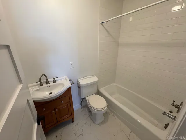 a bathroom with a sink a toilet and a bathtub