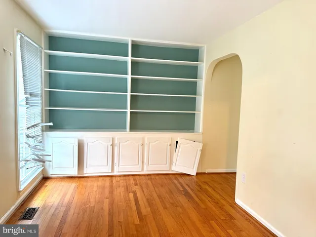 a view of a room with wooden floor and white walls
