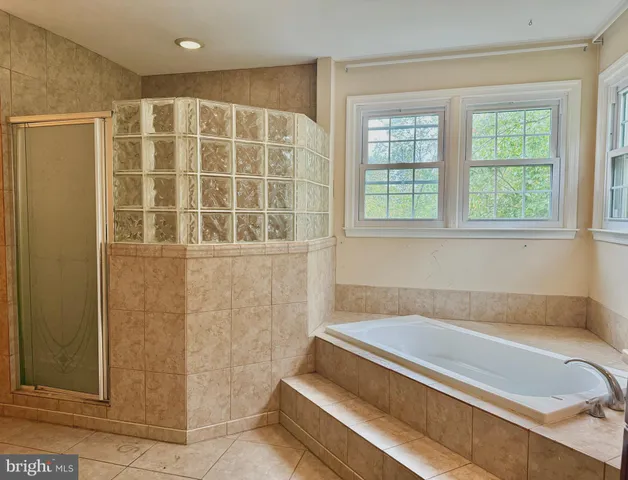 a bathroom with a bathtub and shower