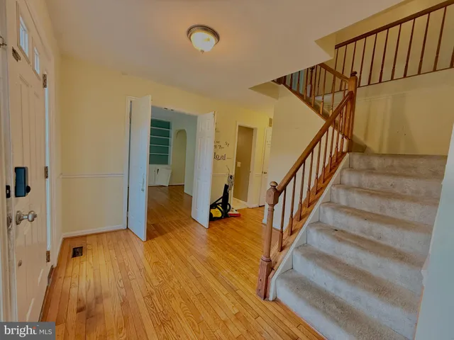 a view of entryway with wooden floor and stairs