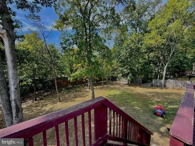 a view of a wooden deck and a yard