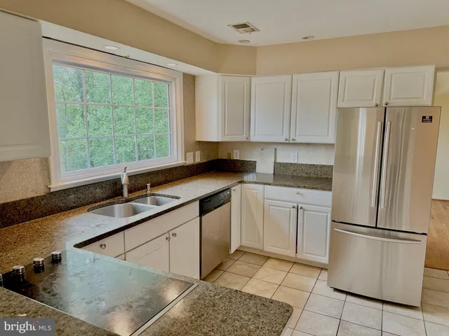a kitchen with a refrigerator a sink and a stove