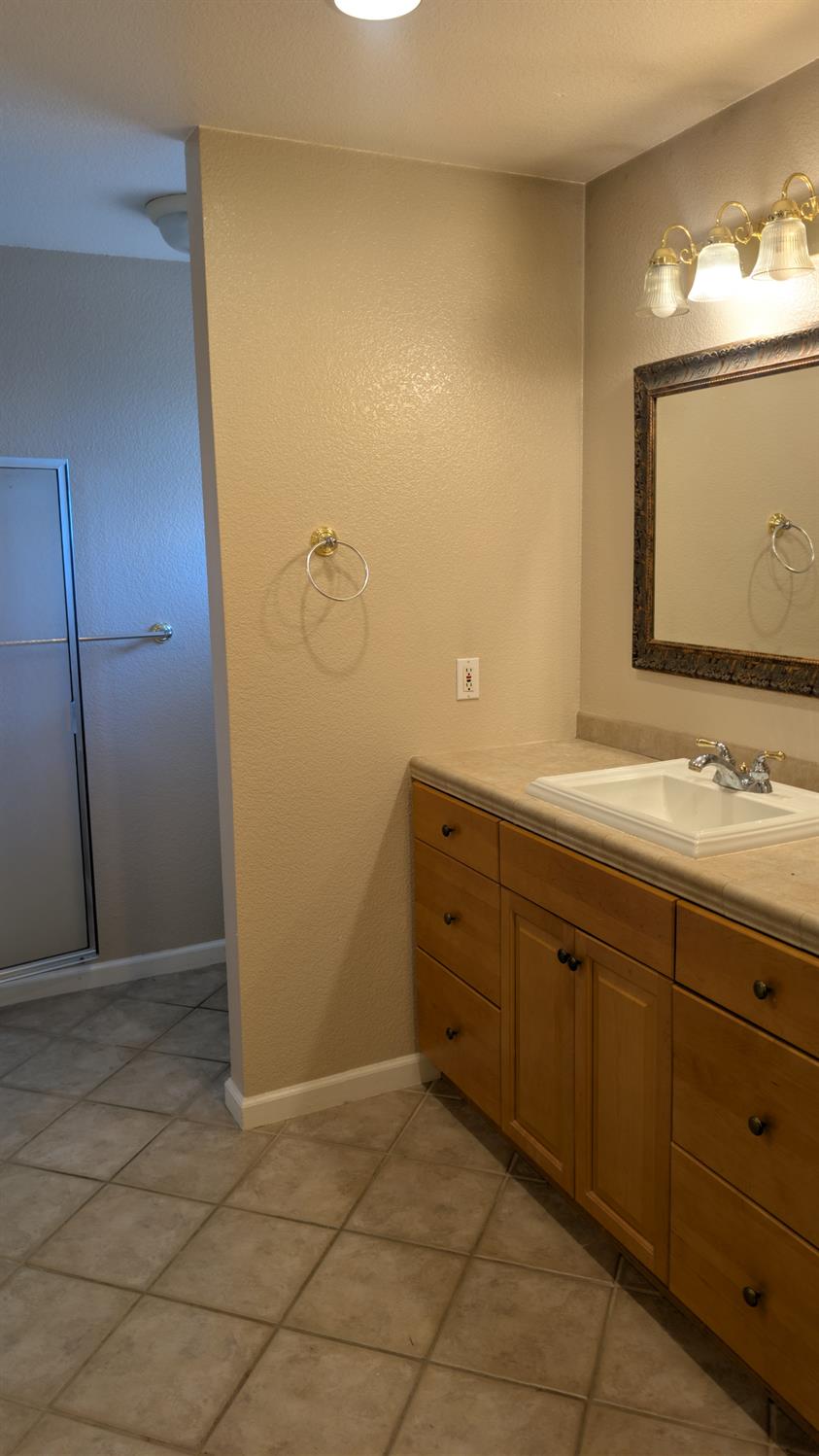 3248 Sudbury Road Cameron Park, CA 95682 - Photo 19 of 41 a bathroom with a sink and a mirror