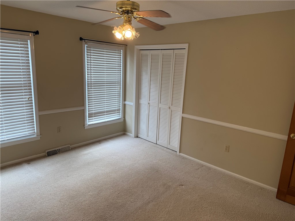 121 Nautical Way Anderson, SC 29625 - Photo 32 of 37 Well-lit room featuring ample natural light, soft carpet, and convenient closet access.