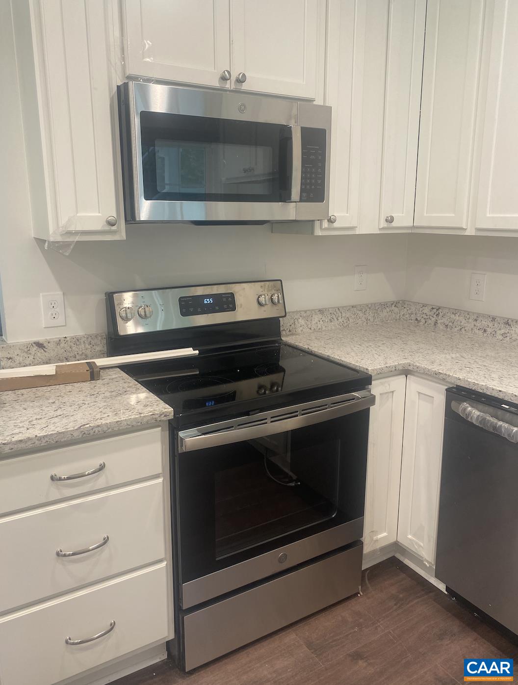 513 Valley Road Charlottesville, VA 22903 - Photo 6 of 22 a kitchen with granite countertop white cabinets and stainless steel appliances