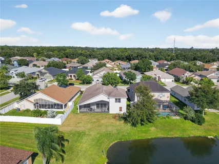 an aerial view of a house with a swimming pool outdoor seating and yard