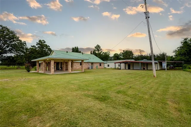 a front view of a house with a big yard