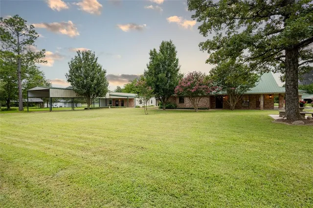 a view of a house with yard and sitting area