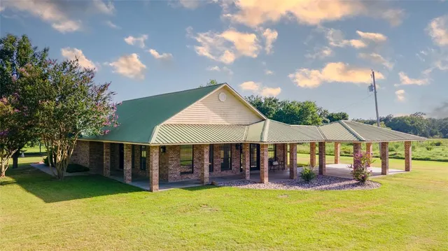 a view of house with swimming pool and patio