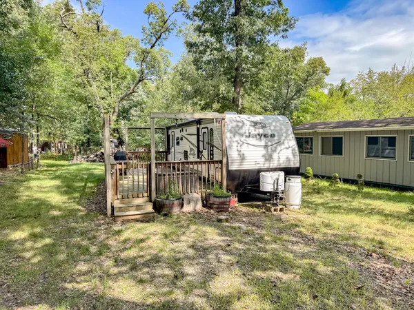 a view of a house with backyard and a tree