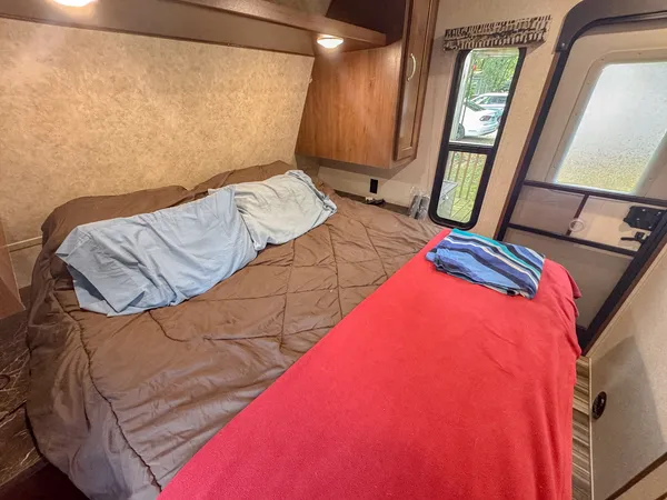 a bed sitting in a bedroom next to a window