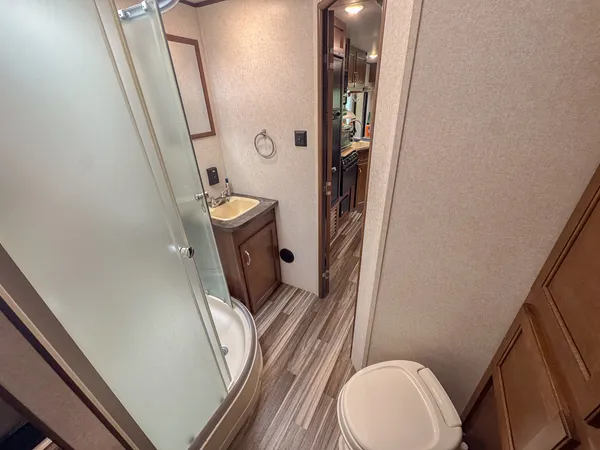 a bathroom with a sink a toilet a mirror and vanity
