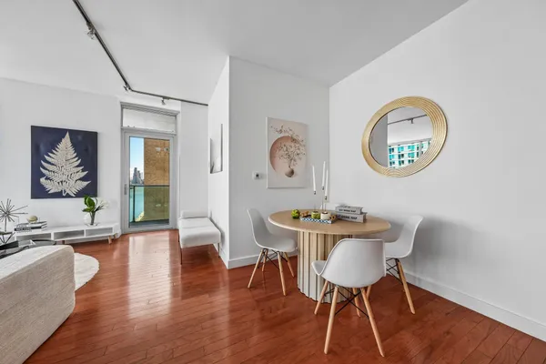 a view of a dining room with furniture wooden floor and a chandelier