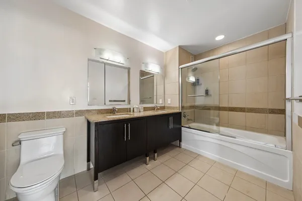 a bathroom with a sink a toilet and shower