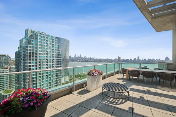 a roof deck with couch and table