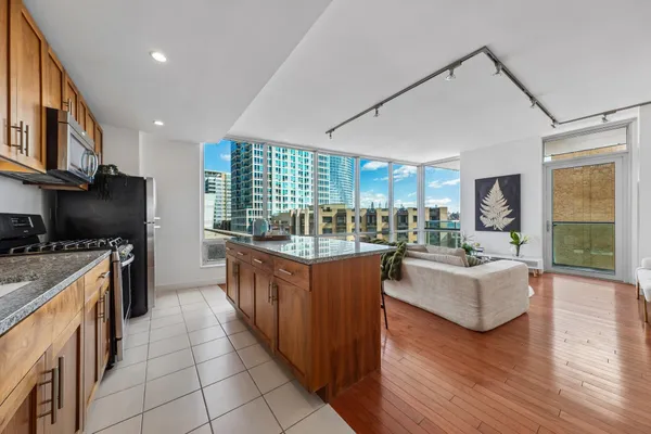 a kitchen with stainless steel appliances granite countertop a stove and a refrigerator