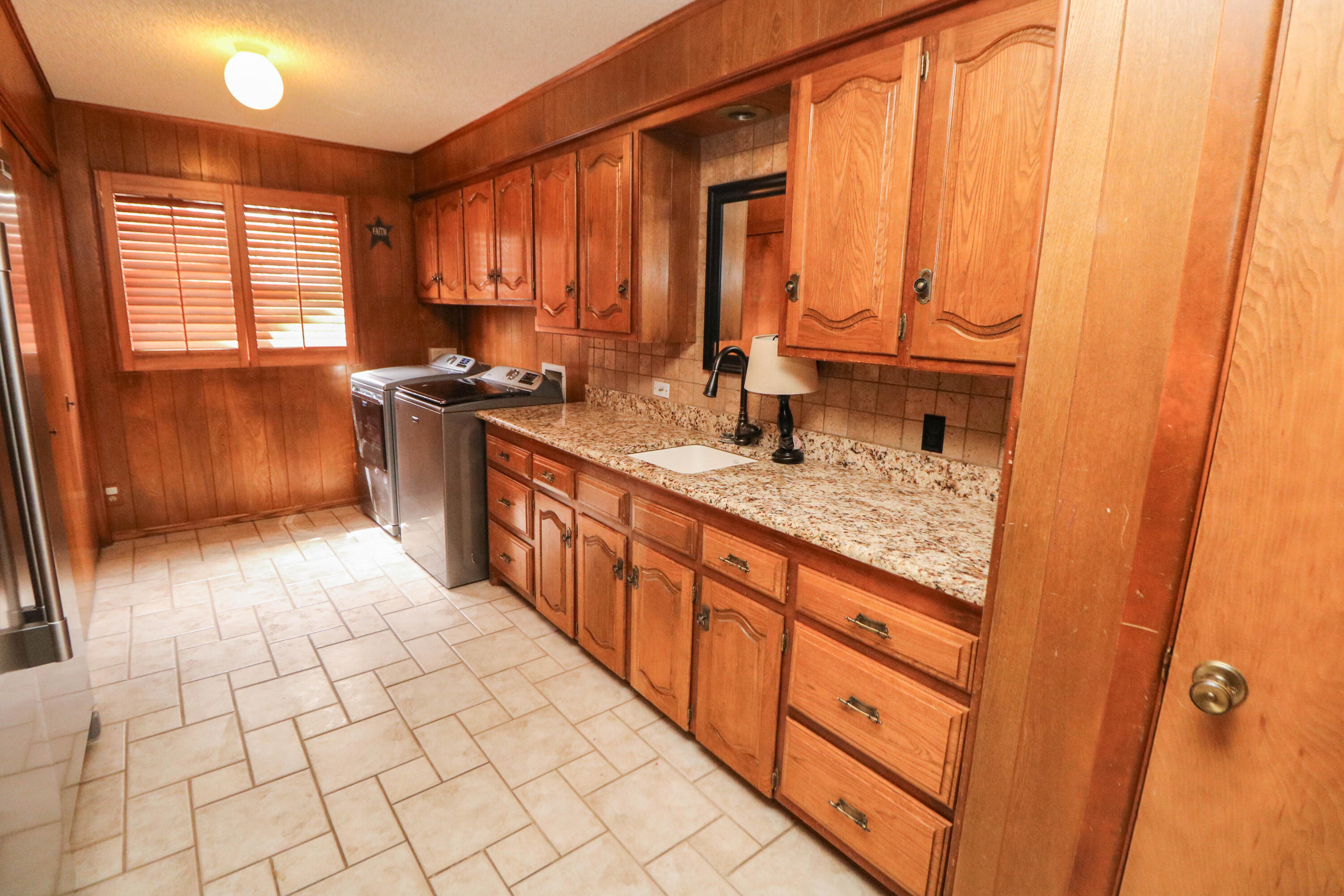 1740 Highway 70 Springlake, TX 79082 - Photo 19 of 39 a large kitchen with kitchen island granite countertop a sink window and cabinets