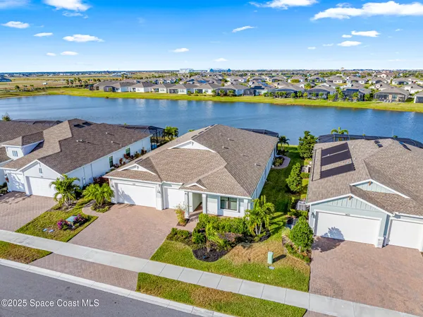an aerial view of a house with a lake view
