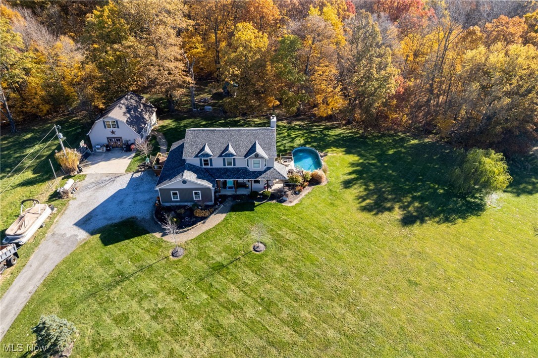 11827 Stratton Road West Salem, OH 44287 - Photo 46 of 47 View from above of property with a pool area and a heavily wooded area
