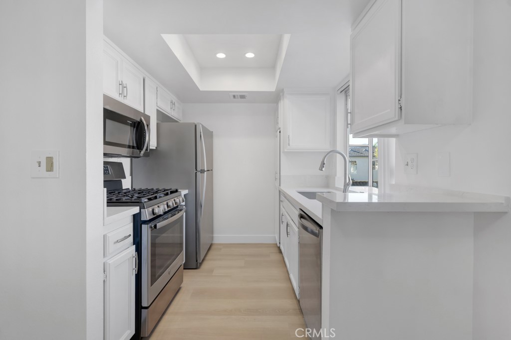 4201 Las Virgenes Road, Unit 206 Calabasas, CA 91302 - Photo 13 of 44 a kitchen with stainless steel appliances granite countertop a refrigerator stove and sink