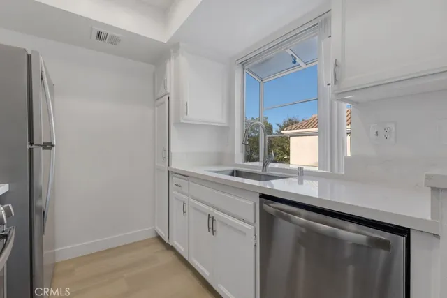 a kitchen with a sink and cabinets