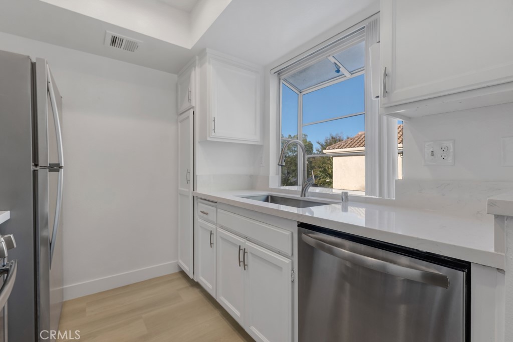 4201 Las Virgenes Road, Unit 206 Calabasas, CA 91302 - Photo 14 of 44 a kitchen with a sink and cabinets