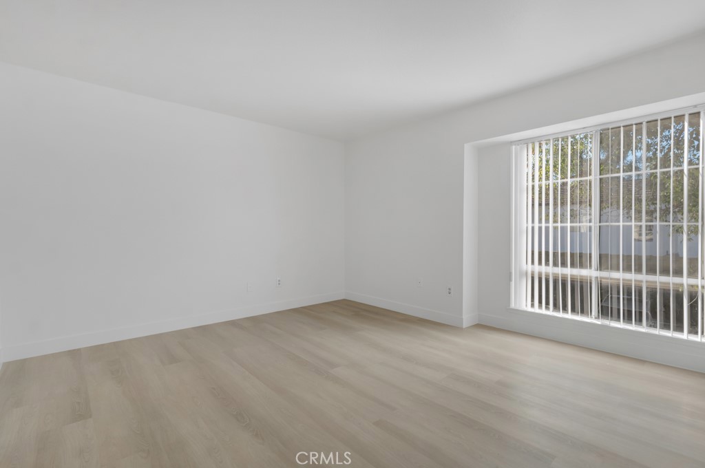 4201 Las Virgenes Road, Unit 206 Calabasas, CA 91302 - Photo 22 of 44 an empty room with wooden floor and windows
