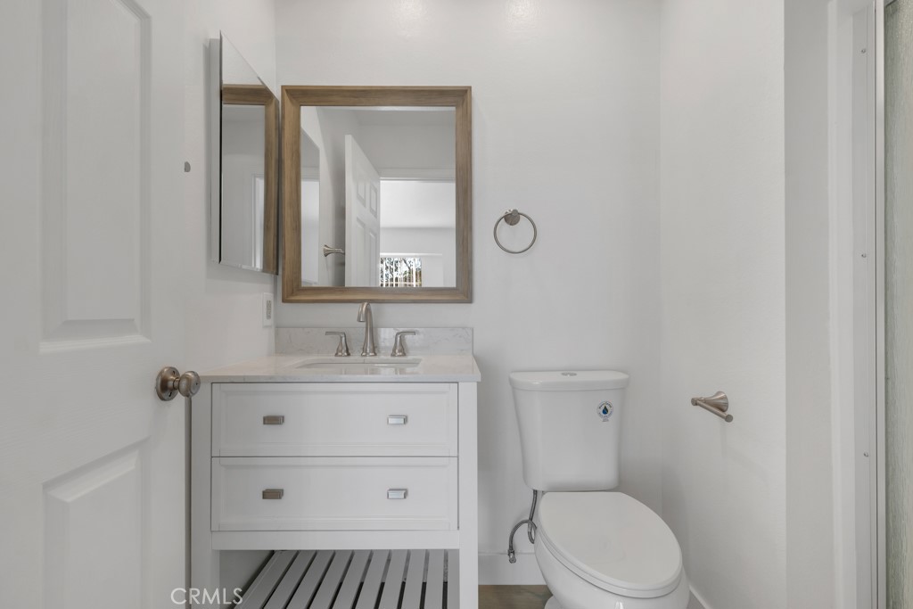 4201 Las Virgenes Road, Unit 206 Calabasas, CA 91302 - Photo 24 of 44 a bathroom with a toilet a sink a vanity and mirror