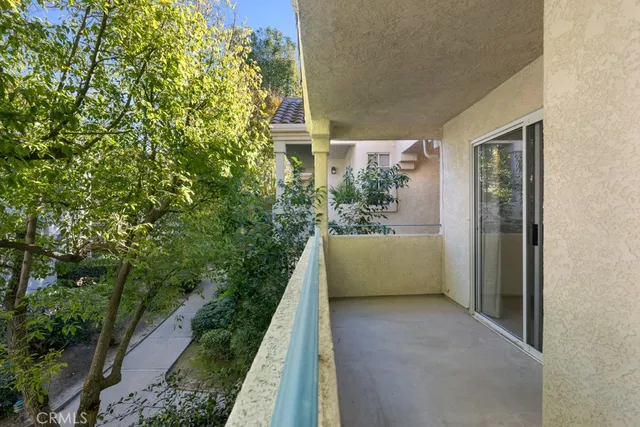 a pathway of a house with a yard and plants