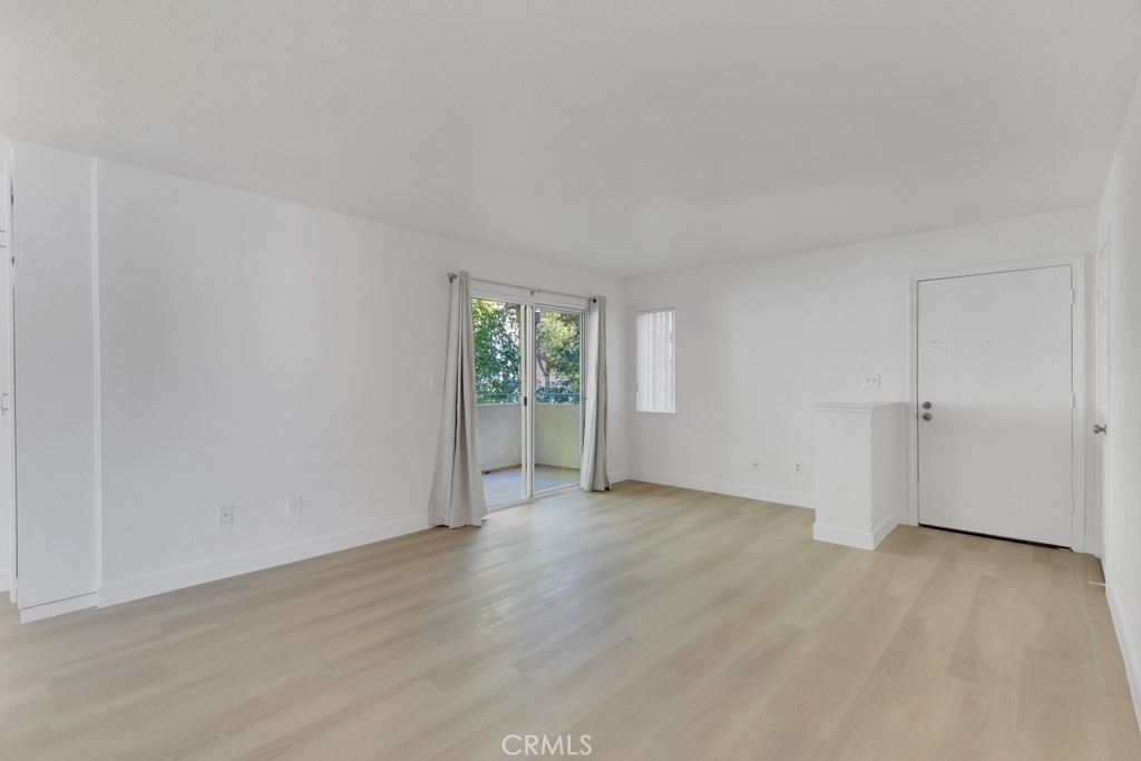 4201 Las Virgenes Road, Unit 206 Calabasas, CA 91302 - Photo 6 of 44 an empty room with wooden floor and windows