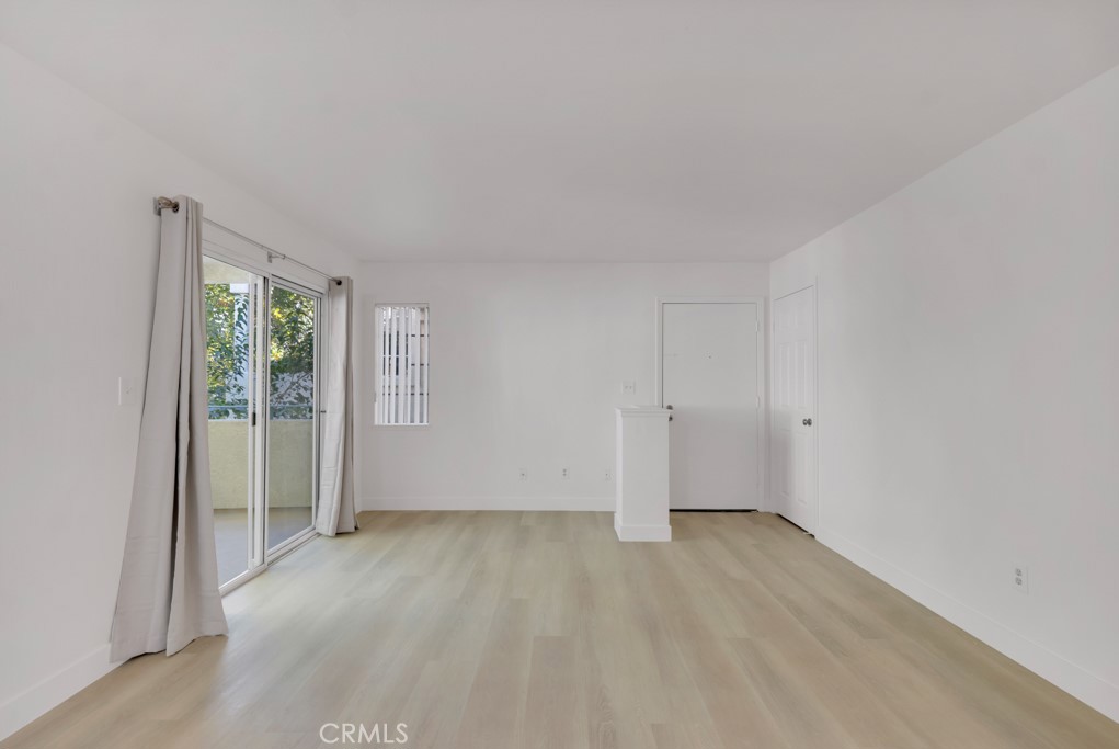 4201 Las Virgenes Road, Unit 206 Calabasas, CA 91302 - Photo 8 of 44 a view of an empty room with wooden floor and a window