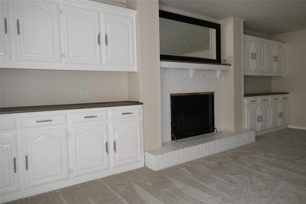 6317 Rincon Way Dallas, TX 75214 - Photo 11 of 32 a living room with furniture a fireplace and a flat screen tv