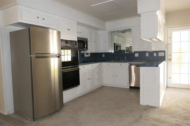 a kitchen with stainless steel appliances a refrigerator sink and stove
