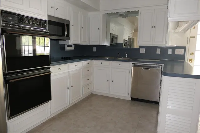 a kitchen with granite countertop cabinets and steel stainless steel appliances