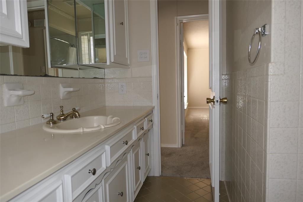 6317 Rincon Way Dallas, TX 75214 - Photo 21 of 32 a bathroom with a sink and a mirror