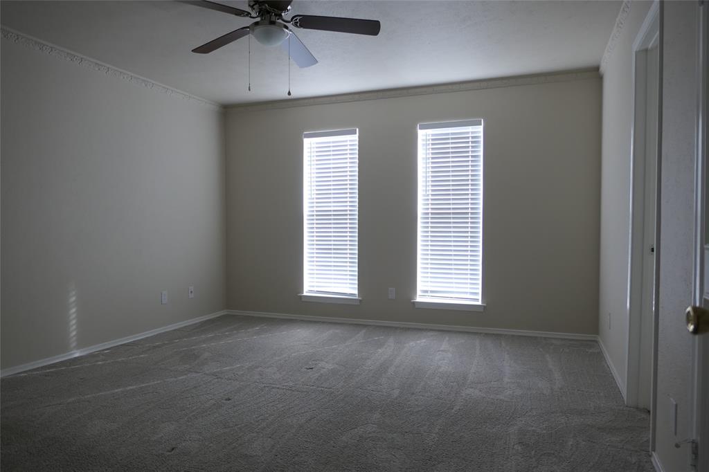 6317 Rincon Way Dallas, TX 75214 - Photo 23 of 32 an empty room with a window and a fan