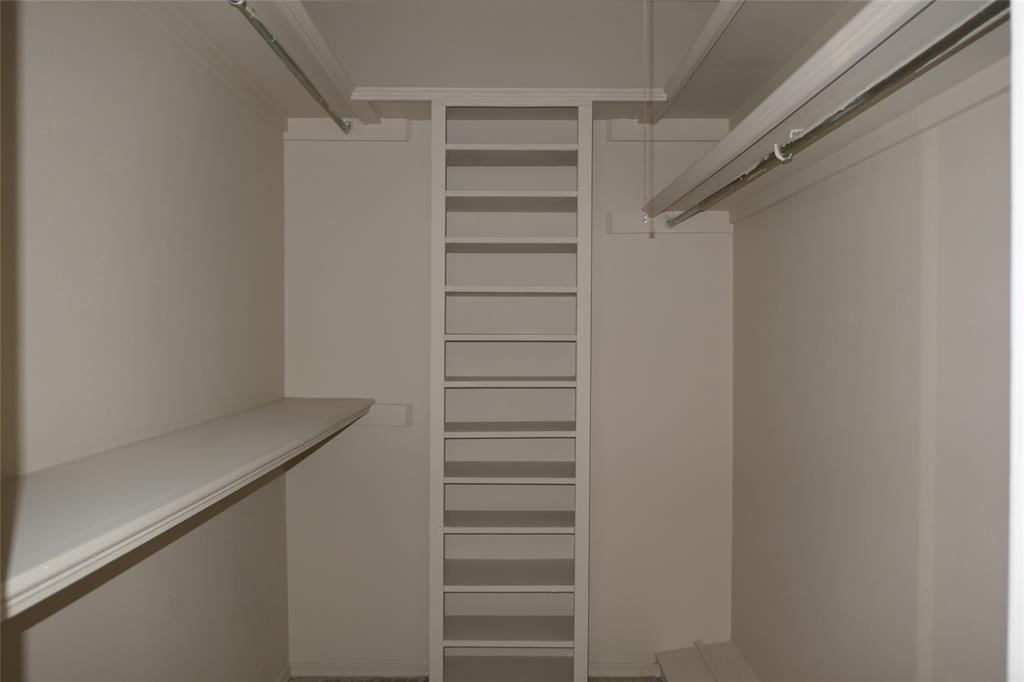 6317 Rincon Way Dallas, TX 75214 - Photo 25 of 32 a view of walk in closet with empty racks