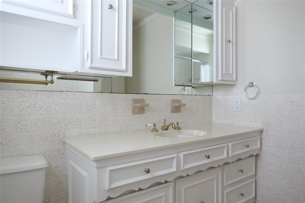 6317 Rincon Way Dallas, TX 75214 - Photo 27 of 32 a bathroom with a sink and a mirror