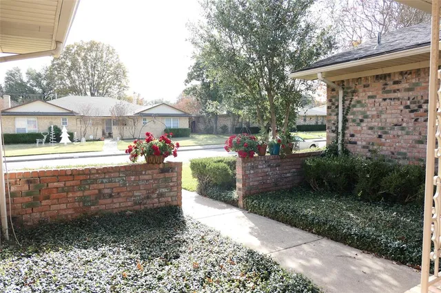 a view of a porch with furniture and garden