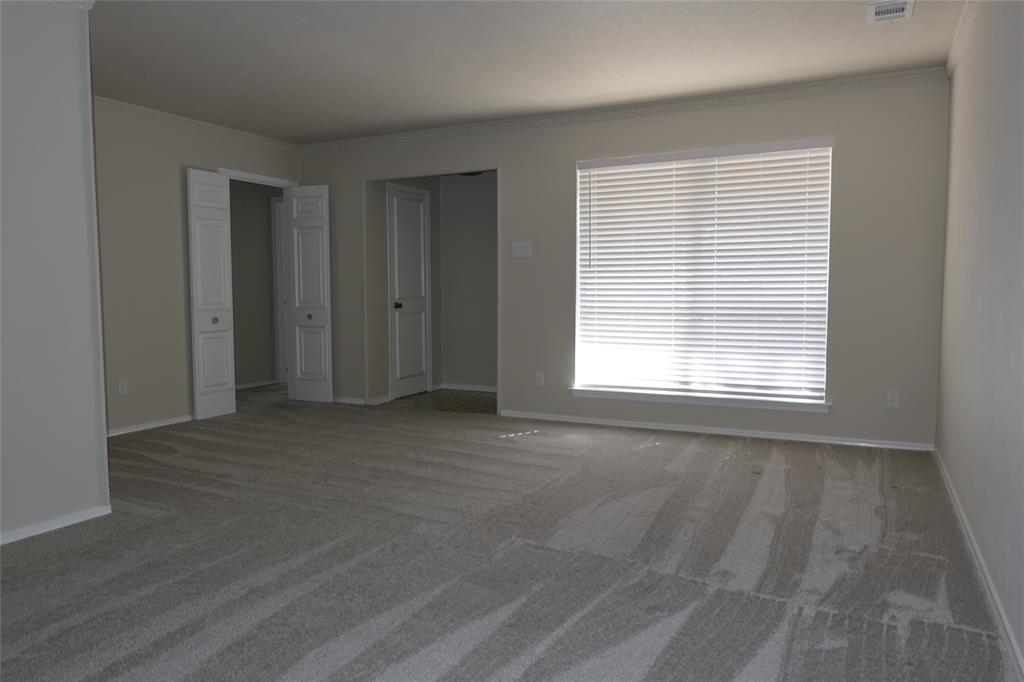 6317 Rincon Way Dallas, TX 75214 - Photo 7 of 32 a view of an empty room with wooden floor and a window
