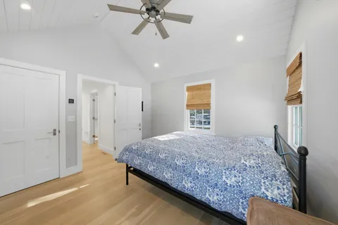 a bathroom with a toilet a sink a mirror a bathtub and shower