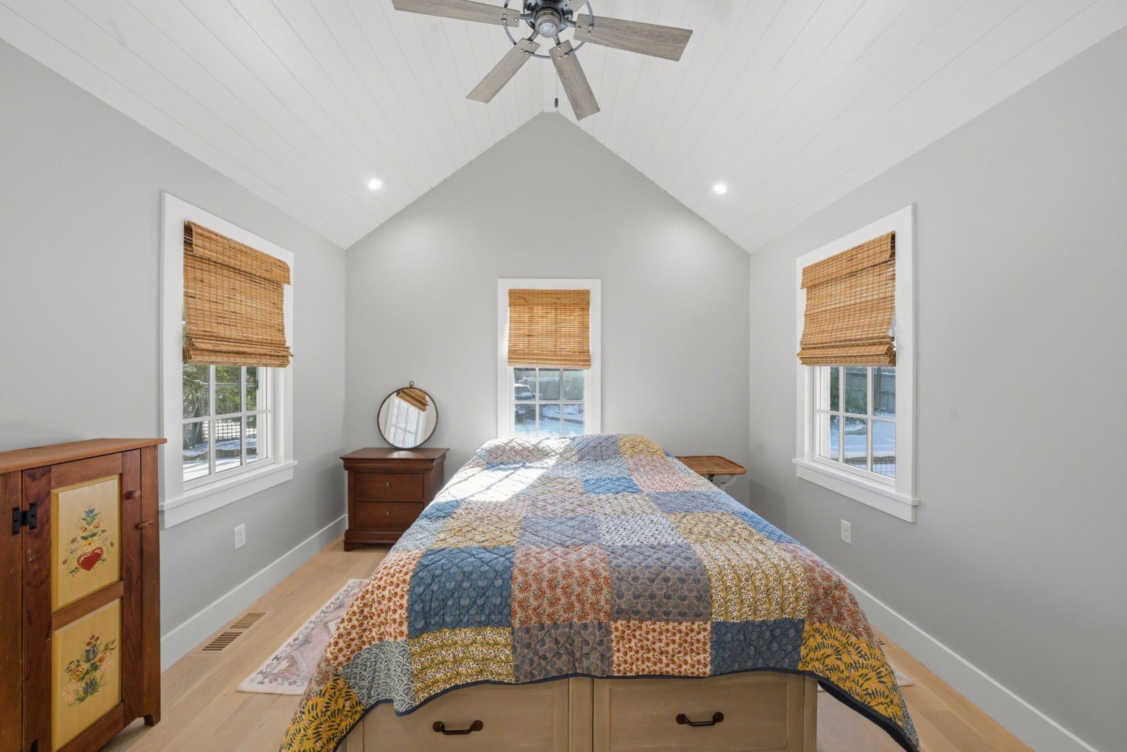10 Fowler Avenue Edgartown, MA 02539 - Photo 14 of 20 a spacious bedroom with a bed a dresser and windows
