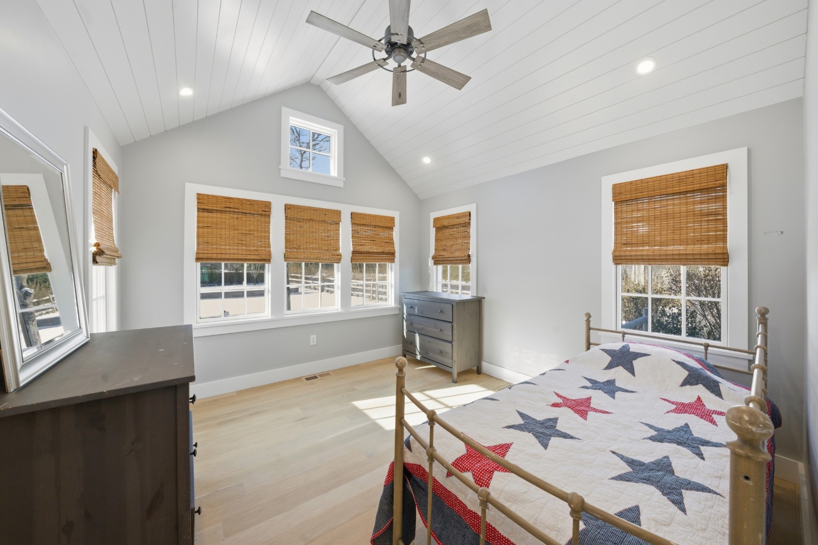 10 Fowler Avenue Edgartown, MA 02539 - Photo 9 of 20 a spacious bedroom with a bed a table and windows