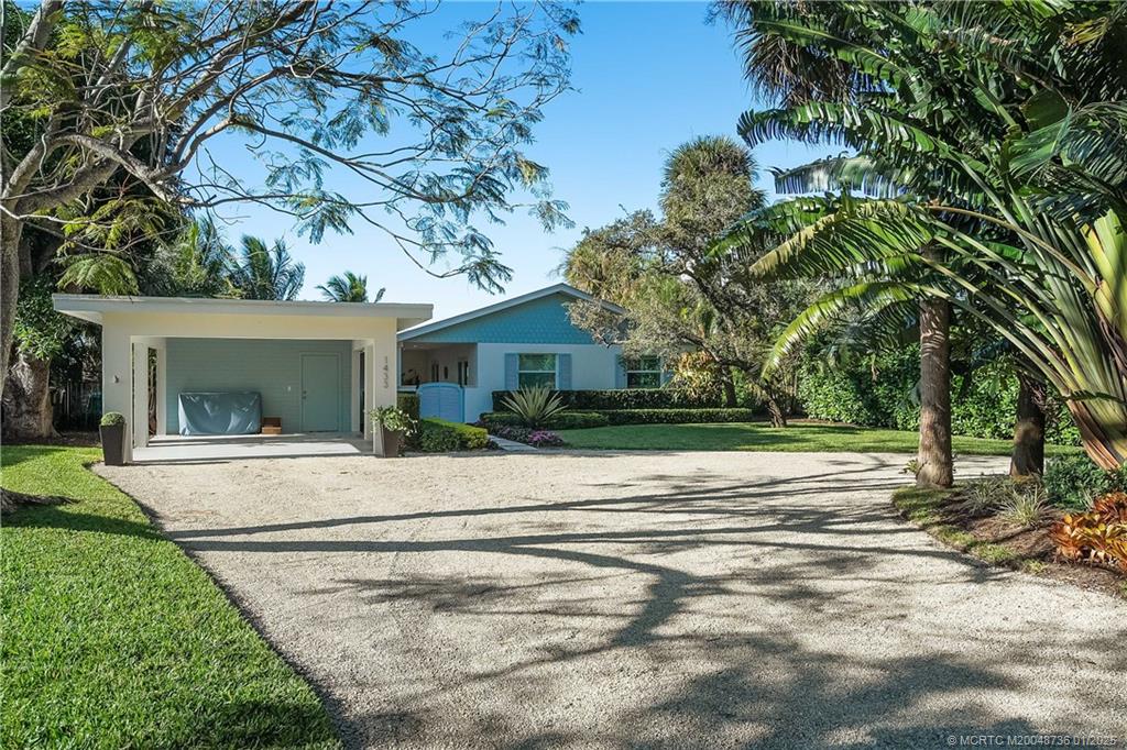1433 Southeast Riverside Drive Stuart, FL 34996 - Photo 54 of 64 front view of a house with a yard and an trees