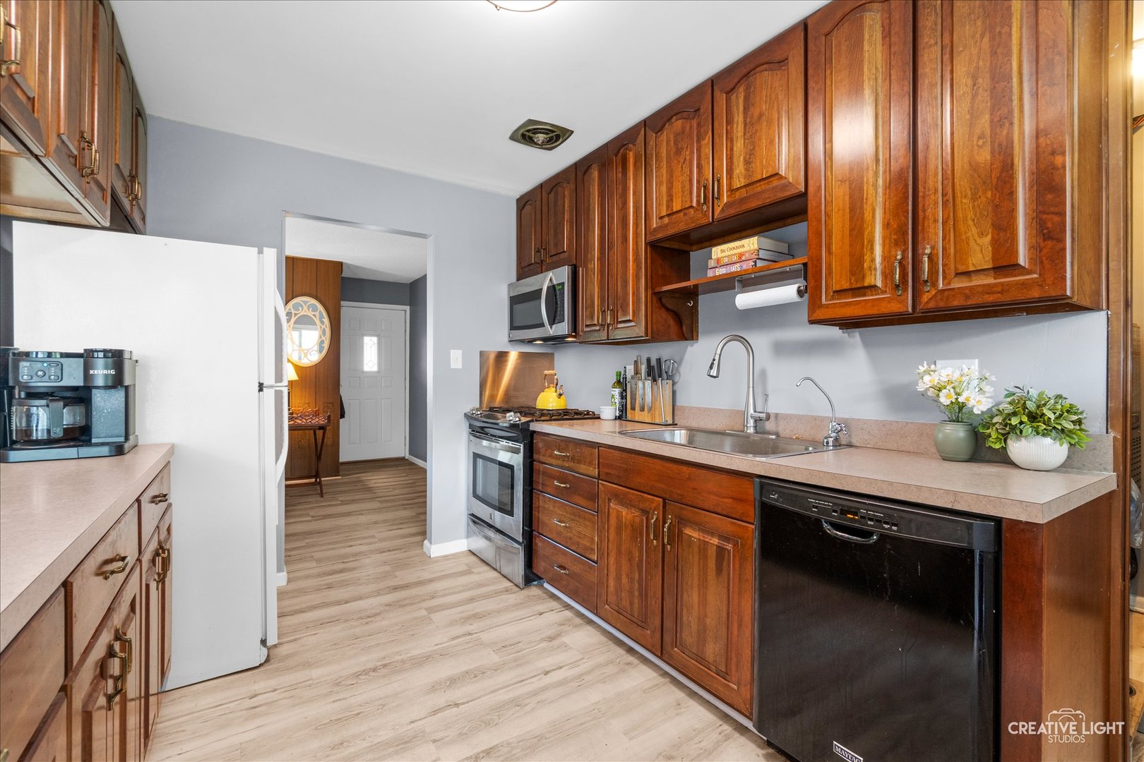 4 Woodcliff Road Montgomery, IL 60538 - Photo 6 of 18 a kitchen with stainless steel appliances granite countertop wooden cabinets a sink and a stove