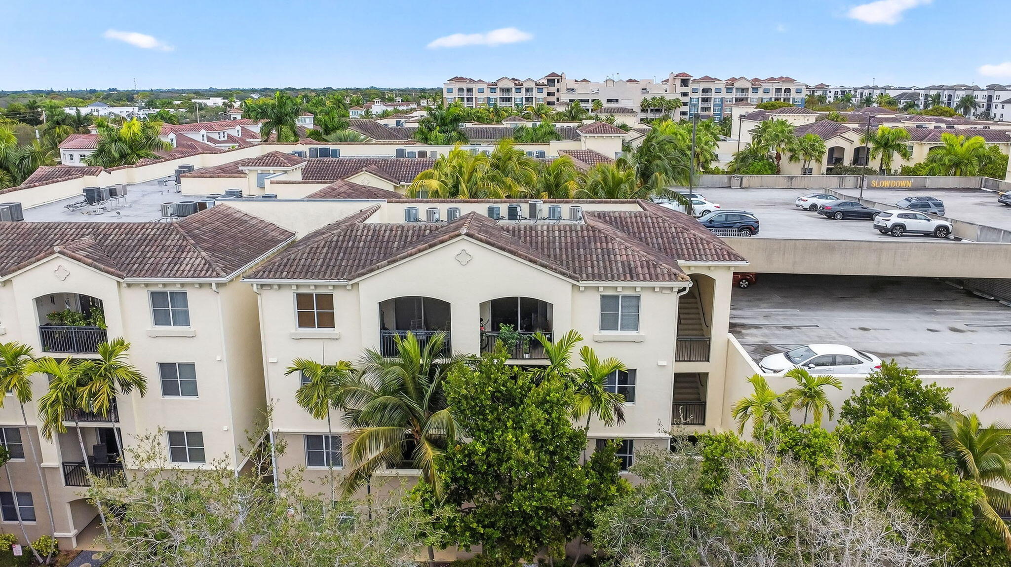 3110 Renaissance Way, Unit 110 Boynton Beach, FL 33426 - Photo 22 of 45 REAR OF BUILDING AND PARKING GARAGE