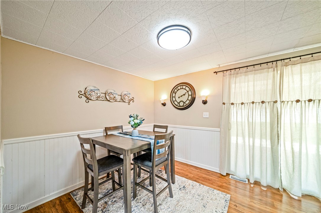 2716 Russell Road Ashtabula, OH 44004 - Photo 7 of 43 Dining room with wood finished floors and a wainscoted wall