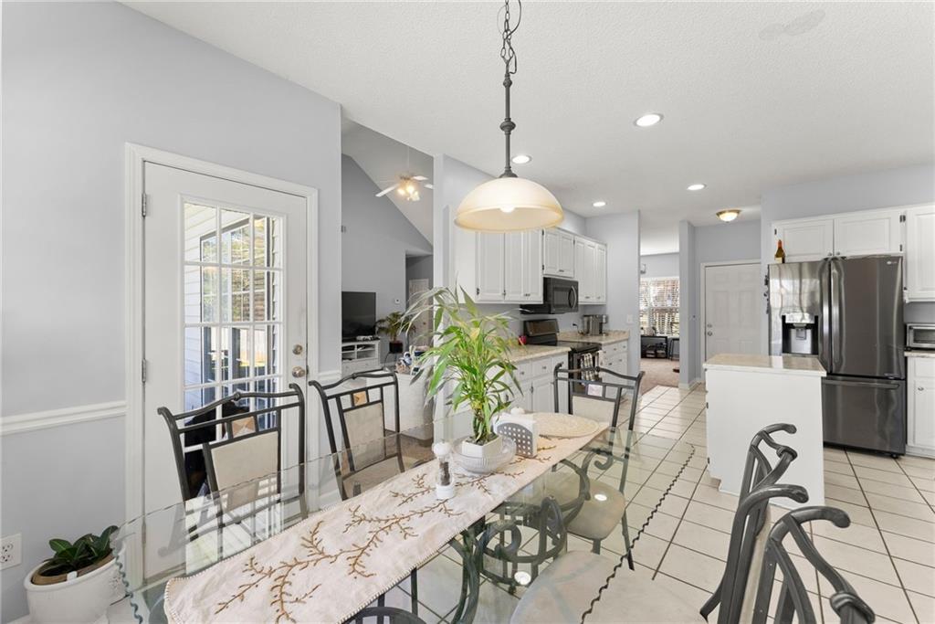 716 Michael Drive Winder, GA 30680 - Photo 12 of 46 a view of a dining room and livingroom with furniture wooden floor a chandelier