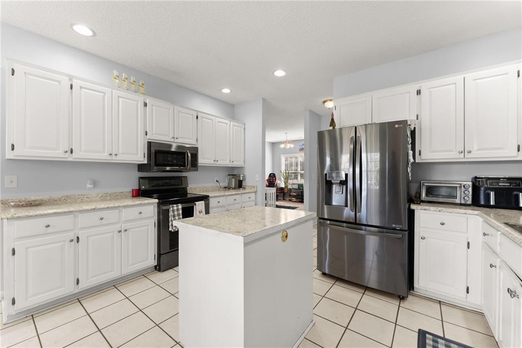 716 Michael Drive Winder, GA 30680 - Photo 14 of 46 a kitchen with cabinets stainless steel appliances and a counter space