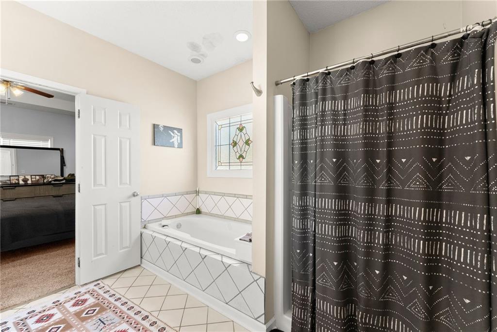 716 Michael Drive Winder, GA 30680 - Photo 21 of 46 a bathroom with a bathtub and a shower